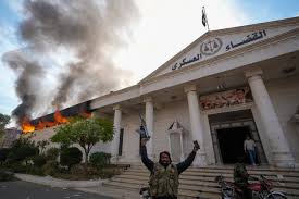 Burning building in Syria with rebel fighters and flags representing the December 2024 fall of the Assad regime