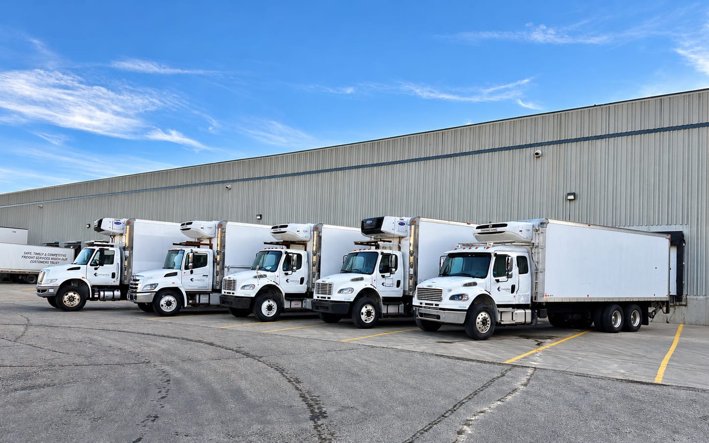 Cangaroo Cartage reefer straight trucks backed into warehouse loading docks