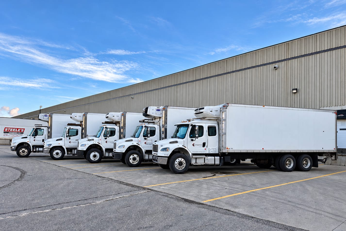 Cangaroo Cartage reefer trucks lined up at warehouse docks